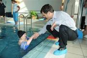 2 June 2009; Timothy Shriver, Chairman and CEO of Special Olympics International was in Dublin today (Tuesday, June 2nd) to visit Special Olympics Ireland athletes, coaches, volunteers and family members at the Ballymun Swimming Club, Dublin. Pictured is Special Olympic athlete Kelsey Brannigan, age 9 from Dublin with Timothy Shriver. Ballymun Swimming Pool, Ballymun Leisure Centre, Dublin. Picture credit: David Maher / SPORTSFILE