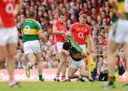 7 June 2009; Graham Canty, Cork, attempts to pick Paul Galvin, Kerry, up off the ground. Munster GAA Football Senior Championship Semi-Final, Kerry v Cork, Fitzgerald Stadium, Killarney, Co. Kerry. Picture credit: Stephen McCarthy / SPORTSFILE