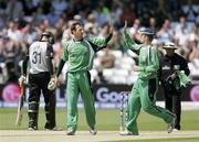 11 June 2009; Alex Cusack, left, Ireland, is congratulated by captain William Porterfield after taking a wicket against New Zealand. Twenty20 World Cup - Super Eights Series, Ireland v New Zealand. Trent Bridge, Nottingham, England. Picture credit: Tim Hales / SPORTSFILE