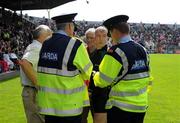 13 June 2009; Referee Pat MeEnaney in conversation with senior Gardai, who decided to delay the throw-in by 15 mins to accomodate the crowd. GAA Football Munster Senior Championship Semi-Final Replay, Cork v Kerry, Pairc Ui Chaoimh, Cork. Picture credit: Brendan Moran / SPORTSFILE