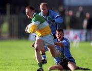 12 November 2000; Neville Coughlan of Offaly is tackled by Shane Ryan and Ian Clarke of Dublin during the Church & General National Football League Division 1A match between Offaly and Dublin at O'Connor Park in Tullamore, Offaly. Photo by Aoife Rice/Sportsfile
