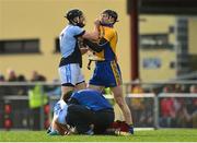 25 October 2015; Cathal King, Na Piarsaigh, and Niall Gilligan, Sixmilebridge, tussle as Na Piarsaigh's Ronan Lynch, Na Piarsaigh, receives treatment for an injury. AIB Munster GAA Senior Club Hurling Championship, Sixmilebridge v Na Piarsaigh. O'Garney Park, Sixmilebridge, Co. Clare. Picture credit: Piaras Ó Mídheach / SPORTSFILE