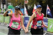 26 October 2015; Sandra Kinsella, Dublin, and Sarah Jane Jones, Fingallians AC, Dublin, on their way to finishing the SSE Airtricity Dublin Marathon 2015, Merrion Square, Dublin. Picture credit: Tomas Greally / SPORTSFILE