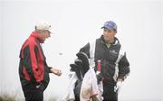 11 July 2009; Padraig Harrington and his caddy Ronan Flood, left, wait for play to resume after a delay due to poor visability on the 2nd during the Ladbrokes.com Irish PGA Championship. European Club, Brittas Bay, Co. Wicklow. Picture credit: Ray Lohan / SPORTSFILE