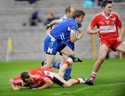 11 July 2009; Paddy Bradley, Derry, lies on the ground against Dessie Mone, Monaghan, after scoring an early goal. GAA Football All-Ireland Senior Championship Qualifier, Round 2, Monaghan v Derry, St Tighearnach's Park, Clones, Co. Monaghan. Picture credit: Oliver McVeigh / SPORTSFILE