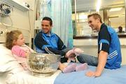 13 July 2009; Dublin football stars Ger Brennan, centre, and captain Paul Griffin with Chloe Finnegan, age 7, from Portmarnock, Co. Dublin, and the Delaney Cup during a visit to Temple Street Children's University Hospital. Children’s University Hospital, Temple Street, Dublin. Picture credit: Brendan Moran / SPORTSFILE