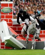 8 August 2009; Jur Vrieling, Netherlands, on Pegasus, crashes at the final fence during the Land Rover Puissance. Fáilte Ireland Dublin Horse Show 2009, RDS, Ballsbridge, Dublin. Photo by Sportsfile