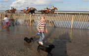 1 September 2009; Five year old Liana Willicombe, from Drogheda, Co. Louth, walks her dogs Peno and Bonny along the beach during the 2nd race. Laytown Races, Laytown, Co. Meath. Photo by Sportsfile