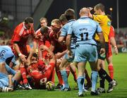 11 September 2009; Denis Leamy, Munster, is helped to his feet by team-mates after scoring his side's second try as referee Peter Allan calls for the TMO. Celtic League, Munster v Cardiff Blues, Thomond Park, Limerick. Picture credit: Diarmuid Greene / SPORTSFILE