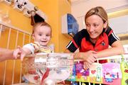 14 September 2009; Cork's Emer Farrell with 14 month old Brendan Reddington, from Galway, with the O'Duffy Cup during a visit to Our Lady's Hospital for Sick Chidren in Crumlin. Crumlin, Dublin. Photo by Sportsfile