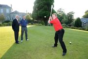 14 September 2009; Former Tipperary All Ireland winner Declan Ryan, from Clonaulty/Rossmore GAA Club, representing Munster, at the 2009 FBD GAA Golf Challenge All-Ireland Final sees how far he can hit a golf ball with a hurley, from the first tee box, watched by Adrian Taheny, Director-Marketing and Sales with FBD, and Armagh footballer Steven McDonnell, from Killeavey GAA Club. 2009 FBD GAA Golf Challenge All-Ireland Final, Faithlegg House Hotel & Golf Club, Co. Waterford. Picture credit: Matt Browne / SPORTSFILE