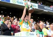 13 September 2009; Offaly captain Marion Crean lifts the New Ireland trophy while An Taoiseach Brian Cowen T.D. looks on at the Gala All-Ireland Camogie Championship Finals. Croke Park, Dublin. Picture credit: Pat Murphy / SPORTSFILE