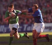 17 February 2001; Tyrone Howe of Ireland is tackled by Richard Dourthe of France during the Lloyds TSB Six Nations Rugby Championship match between Ireland and France at Lansdowne Road in Dublin. Photo by Matt Browne/Sportsfile