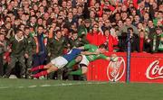 17 February 2001; Brian O'Driscoll of Ireland goes over for a try despite the efforts of Xavier Garabajosa of France during the Lloyds TSB Six Nations Rugby Championship match between Ireland and France at Lansdowne Road in Dublin. Photo by Brendan Moran/Sportsfile