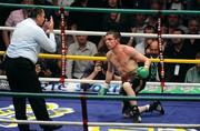 26 September 2009; A groggy Bernard Dunne is given a count by referee Jean Louis Legland during the third round of his WBA World Super Bantamweight title fight. Hunky Dorys World Title Fight Night, Bernard Dunne v Poonsawat Kratingdaenggym, The O2, Dublin. Picture credit: Stephen McCarthy / SPORTSFILE