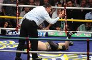 26 September 2009; Bernard Dunne is given a count by referee Jean Louis Legland during the third round of his WBA World Super Bantamweight title fight. Hunky Dorys World Title Fight Night, Bernard Dunne v Poonsawat Kratingdaenggym, The O2, Dublin. Picture credit: Stephen McCarthy / SPORTSFILE