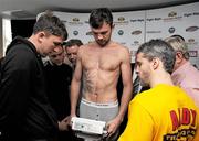 13 November 2009; Andy Lee steps onto the scales watched by his brother Roger, left, and trainer Joey Gamache, right, during the pre-fight weigh-in ahead of his Yanjing Fight Night against Affif Belghecham on Saturday. George Boutique Hotel, Limerick. Picture credit: Diarmuid Greene / SPORTSFILE