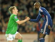 14 November 2009; William Gallas, France, helps Kevin Doyle, Republic of Ireland, to his feet. FIFA 2010 World Cup Qualifying Play-off 1st Leg, Republic of Ireland v France, Croke Park, Dublin. Picture credit: Stephen McCarthy / SPORTSFILE