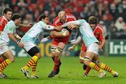 11 December 2009; Paul O'Connell, Munster, is tackled by Farid Sid, left, Maxime Mermoz, and Bertrand Guiry, right, Perpignan. Heineken Cup Pool 1 Round 3, Munster v Perpignan, Thomond Park, Limerick. Picture credit: Diarmuid Greene / SPORTSFILE