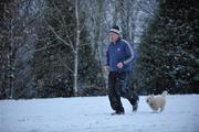 11 January 2010; A man jogs with his dog on the snow covered University of Limerick sports grounds. University of Limerick, Limerick. Picture credit: Diarmuid Greene / SPORTSFILE