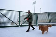 11 January 2010; Paddy Bruen from Clareview, Limerick, with Winnie the dog, walks carefully through the snow outside the Gaelic Grounds. Ennis Road, Limerick. Picture credit: Diarmuid Greene / SPORTSFILE