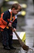 8 April 2001; A young Kilkenny Fan plays with his hurl in a puddle of water during the Allianz GAA National Hurling League Division 1B Round 4 match between Kilkenny and Tipperary at Nowlan Park in Kilkenny. Photo by Damien Eagers/Sportsfile