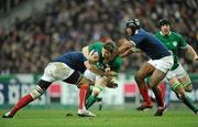 13 February 2010; Brian O'Driscoll, Ireland, is tackled by Imanol Harinordoquy, left, and theirry Dusautoir, France. RBS Six Nations Rugby Championship, France v Ireland, Stade de France, Saint Denis, Paris, France. Picture credit: Brendan Moran / SPORTSFILE