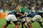 13 February 2010; Leo Cullen supported by Ronan O'Gara, Ireland, is tackled by Mathieu Bastareaud, left, and Fulgence Ouedraogo, France. RBS Six Nations Rugby Championship, France v Ireland, Stade de France, Saint Denis, Paris, France. Picture credit: Brian Lawless / SPORTSFILE