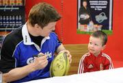 15 February 2010; Ryan Greally, age 3, from Stillorgan, Co. Dublin, gets a ball signed by Gillette Ambassador and Irish Rugby captain Brian O’Driscoll at an in-store signing in Dunnes Stores, Cornelscourt, on Monday evening. The rugby hero took the time to sign autographs and meet hundreds of fans as he launched the Gillette Fusion limited edition Irish handle razor. A limited edition razor has been specially designed donning the Irish colours to show Ireland’s pride in the rugby star and his Irish team-mates. The crowd were delighted to get the opportunity to meet the rugby star before he lines out for his next RBS 6 Nations match against England. Dunnes Stores, Cornelscourt, Dublin. Picture credit: Brendan Moran / SPORTSFILE