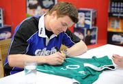 15 February 2010; Gillette Ambassador and Irish Rugby captain Brian O’Driscoll signs an Irish jersey at an in-store signing in Dunnes Stores, Cornelscourt, on Monday evening. The rugby hero took the time to sign autographs and meet hundreds of fans as he launched the Gillette Fusion limited edition Irish handle razor. A limited edition razor has been specially designed donning the Irish colours to show Ireland’s pride in the rugby star and his Irish team-mates. The crowd were delighted to get the opportunity to meet the rugby star before he lines out for his next RBS 6 Nations match against England. Dunnes Stores, Cornelscourt, Dublin. Picture credit: Brendan Moran / SPORTSFILE