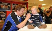 15 February 2010; Liam Kearns, age 15 months, from Dalkey, Co. Dublin, looks on inquisitively as he gets a jersey signed by Gillette Ambassador and Irish Rugby captain Brian O’Driscoll at an in-store signing in Dunnes Stores, Cornelscourt, on Monday evening. The rugby hero took the time to sign autographs and meet hundreds of fans as he launched the Gillette Fusion limited edition Irish handle razor. A limited edition razor has been specially designed donning the Irish colours to show Ireland’s pride in the rugby star and his Irish team-mates. The crowd were delighted to get the opportunity to meet the rugby star before he lines out for his next RBS 6 Nations match against England. Dunnes Stores, Cornelscourt, Dublin. Picture credit: Brendan Moran / SPORTSFILE