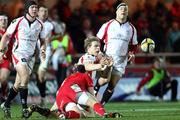 5 March 2010; Andrew Trimble, Ulster, gets his pass away despite the efforts of  Richie Pugh, Llanelli Scarlets. Celtic League, Llanelli Scarlets v Ulster, Parc Y Scarlets, Llanelli, Wales. Picture credit: Steve Pope / SPORTSFILE