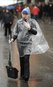 19 March 2010; A cleaner takes cover from the rain during Gold Cup day at the festival. Cheltenham Racing Festival - Friday. Prestbury Park, Cheltenham, Gloucestershire, England. Picture credit: Stephen McCarthy / SPORTSFILE