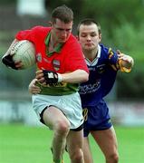 20 May 2001; Mark Carpenter of Carlow is challenged by Mark Coffey of Wicklow during the Bank of Ireland All-Ireland Senior Football Championship First Round Replay match between Wicklow and Carlow at St Conleth's Park in Newbridge, Kildare. Photo by Pat Murphy/Sportsfile