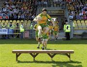 11 April 2010; Donegal Captain Kevin Cassidy, hurdles the team bench as he runs out for the team picture. Allianz GAA Football National League Division 2 Round 7, Donegal v Armagh, O'Donnell Park, Letterkenny, Co. Donegal. Picture credit: Oliver McVeigh / SPORTSFILE