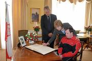 14 April 2010; Mary Davis, Managing Director, Special Olympics Europe / Eurasia, in the company of Polish Ambassador to Ireland Dr. Tadeusz Szumowski and Special Olympics Athlete Dermot Leavy, signs a book of condolence at the Polish Embassy in Dublin in memory of Polish President Mr. Lech Kaczynski, First Lady Mrs Maria Kaczynska and 95 others who died in a plane crash in Russia last Saturday. Mr & Mrs Kaczynska were strong supporters of the Special Olympics movement and were involved in Poland’s preparation to host the 2010 European Games in September. Afterwards the Special Olympics delegation met with the Ambassador to convey, on behalf of the Special Olympics movement in Europe, their deepest condolences to the people of Poland. Embassy of the Republic of Poland, Ballsbridge, Dublin. Picture credit: Brendan Moran / SPORTSFILE