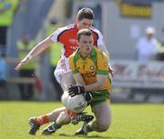 11 April 2010; Brian Mallon, Armagh, has his shot blocked by Neil McGee, Donegal. Allianz GAA Football National League Division 2 Round 7, Donegal v Armagh, O'Donnell Park, Letterkenny, Co. Donegal. Picture credit: Oliver McVeigh / SPORTSFILE