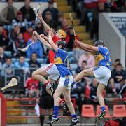 28 April 2010; Darren Sweetnam, Cork, in action against Davin Flynn and Dan McCormack, Tipperary. ESB GAA Munster Minor Hurling Championship Quarter-Final, Cork v Tipperary, Pairc Ui Chaoimh, Cork. Picture credit: Matt Browne / SPORTSFILE