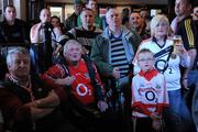 2 May 2010; Munster supporters, wearing Cork jerseys, Ray Lucy, from Passage in Cork and nine year old Scott Downey watch the Biarritz Olympique v Munster - Heineken Cup Semi-Final in the bar in Hayes Hotel, Thurles. Allianz GAA Hurling National League Finals. Semple Stadium, Thurles, Co Tipperary. Picture credit: Ray McManus / SPORTSFILE