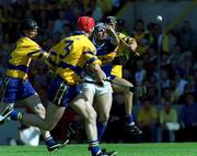 3 June 2001; John Leahy of Tipperary handpasses away despite the attentions of Clare players, from left, Gerry Quinn, Frank Lohan, 2, and Brian Lohan during the Guinness Munster Senior Hurling Championship Semi-Final match between Tipperary and Clare at Páirc Uí Chaoimh in Cork. Photo by Ray McManus/Sportsfile