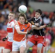16 May 2010; Paul McGeown, Armagh, in action against Rory Moore and Daniel McKinless, Derry. ESB Ulster GAA Football Minor Championship, Derry v Armagh, Celtic Park, Derry. Picture credit: Oliver McVeigh / SPORTSFILE