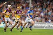 3 July 2010; Gearoid Ryan, Tipperary, in action against David Redmond, 7, and Colm Farrell, Wexford. GAA Hurling All-Ireland Senior Championship Phase 1, Tipperary v Wexford, Semple Stadium, Thurles, Co. Tipperary. Picture credit: Ray McManus / SPORTSFILE