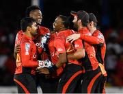 1 July 2016; Umar Akmal, from left, Ronsford Beaton, Dwayne Bravo and Trinbago Knight Riders celebrating during Match 3 of the Hero Caribbean Premier League between Trinbago Knight Riders and Tridents at Queen's Park Oval in Port of Spain, Trinidad. Photo by: Randy Brooks/Sportsfile