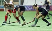 17 August 2010; Erin Goad, New Zealand, in action against Rebecca Barry, 3, and Joanne Orr, 3, Ireland, during their girl's preliminary hockey match. New Zealand defeated Ireland 3-2. 2010 Youth Olympic Games, Sengkang Hockey Stadium, Singapore.