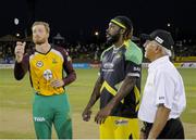 7 July 2016; Martin Guptill, left, of Guyana Amazon Warriors tosses the coin as Chris Gayle, centre, of Jamaica Tallawahs and match referee Dev Govindjee looks on at the start of Match 9 of the Hero Caribbean Premier League between Guyana Amazon Warriors and Jamaica Tallawahs at Guyana National Stadium in Providence, Guyana. Photo by Randy Brooks/Sportsfile