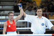 22 August 2010; Ryan Burnett, Ireland, is announced victorous over Zohidjon Hoorboyev, Uzbekistan, following their Men's Light Fly 48Kg Semi-Final. Burnett won the bout 2-1 to advance to the final. 2010 Youth Olympic Games, Bisham Stadium, Singapore. Picture credit: James Veale / SPORTSFILE