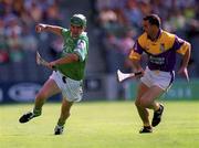 29 July 2001; Mike O'Brien of Limerick in action against Larry O'Gorman of Wexford during the Guinness All-Ireland Senior Hurling Championship Quarter-Final match between Wexford and Limerick at Croke Park in Dublin. Photo by Damien Eagers/Sportsfile
