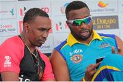 15July 2016; Dwayne Bravo (L) and Kieron Pollard (R) have talk after a pre-match press conference ahead of match 16  of the Hero Caribbean Premier League between Barbados Tridents and Trinbago Knight Riders at Kensington Oval in Bridgetown, Barbados. Photo by Ashley Allen/Sportsfile