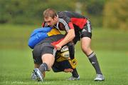 7 September 2010; Munster's Johne Murphy, right, defends a challenge from Ronan O'Gara during squad training ahead of their Celtic League match against Edinburgh on Friday. Munster rugby squad training, University of Limerick, Limerick. Picture credit: Barry Cregg / SPORTSFILE