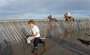 7 September 2010; Six year old Hugh Fawrey, from Laytown, Co. Meath, mimics the horse riders as they gallop towards the starting post for the Balmarino Handicap. Laytown Races, Laytown, Co. Meath. Picture credit: Oliver McVeigh / SPORTSFILE